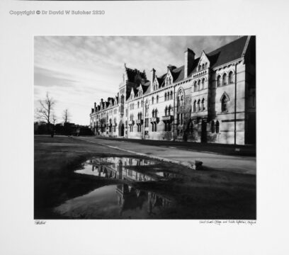 England, Oxford Christ Church College entrance reflected in a puddle.