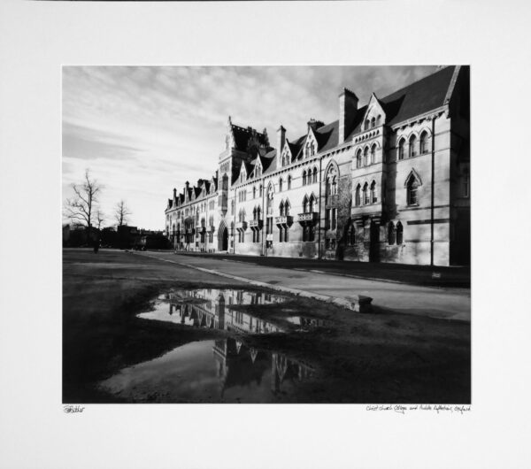 England, Oxford Christ Church College entrance reflected in a puddle.