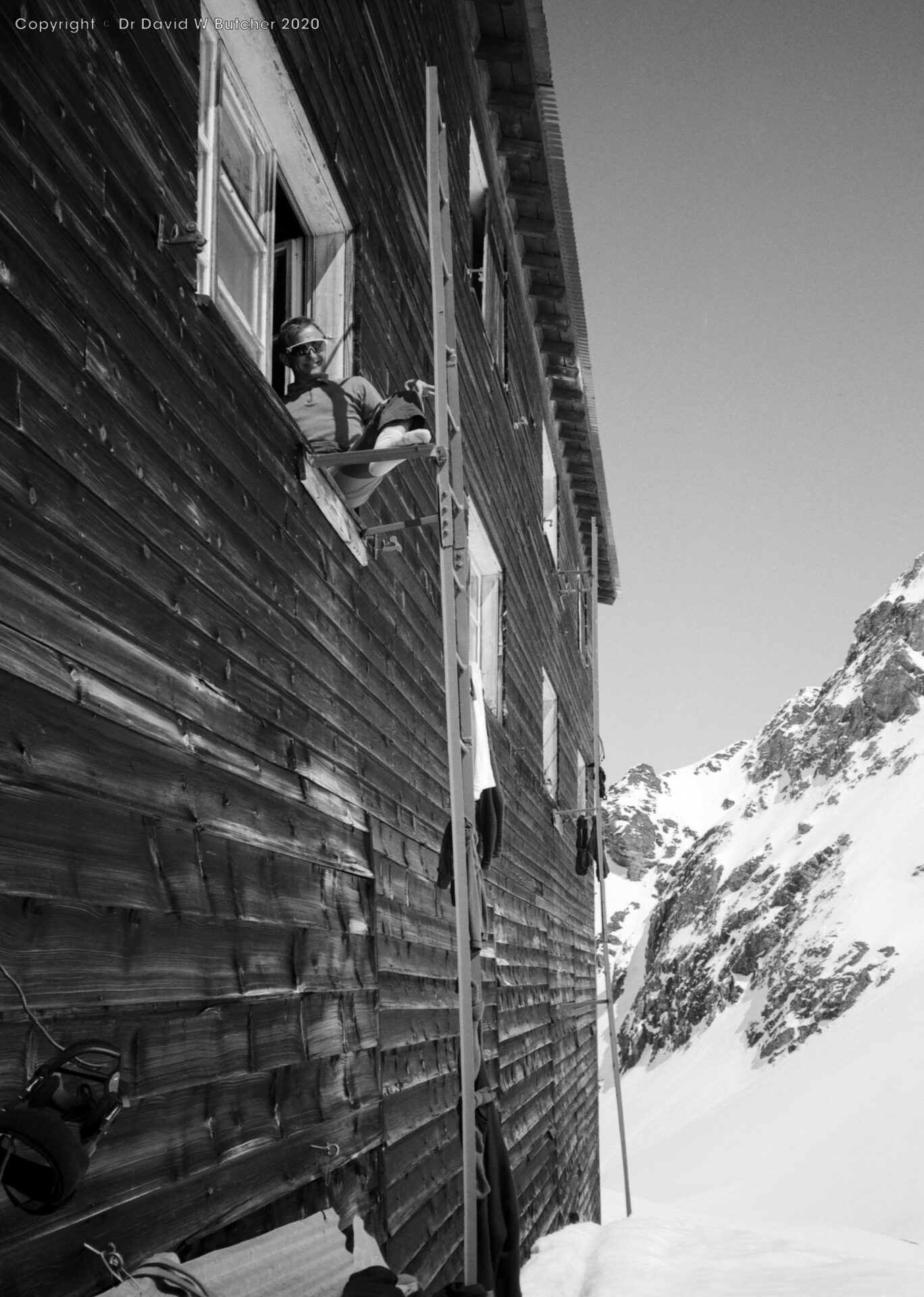 Richard Masters aspirant guide sitting on window ledge at Cabane de Prafleuri, ski Haute Route day 3