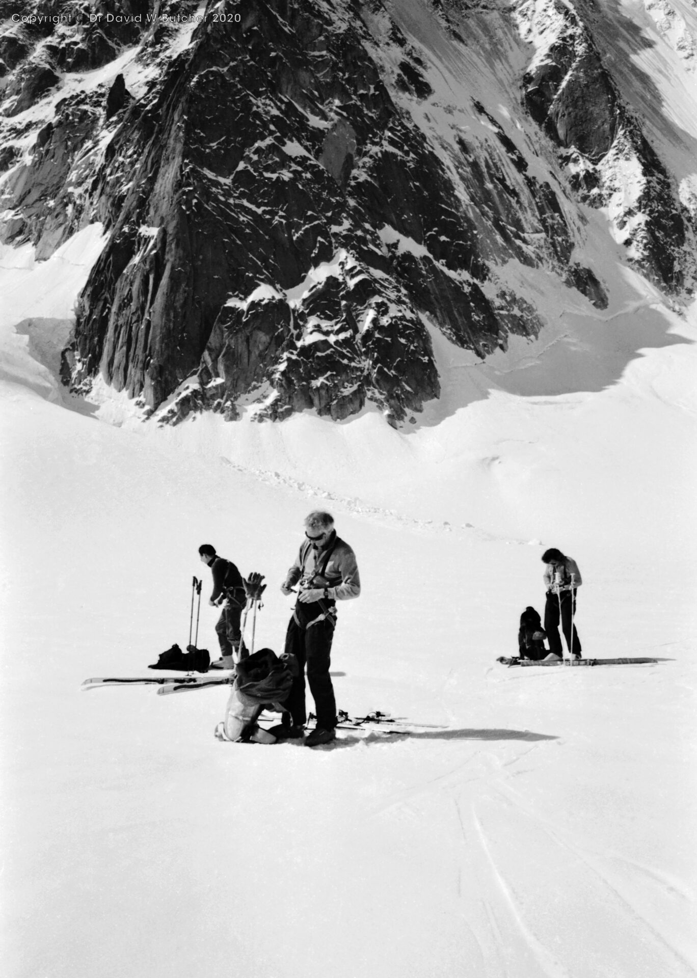 Putting skins on skis on Argentiere Glacier, Peter Cliff in middle